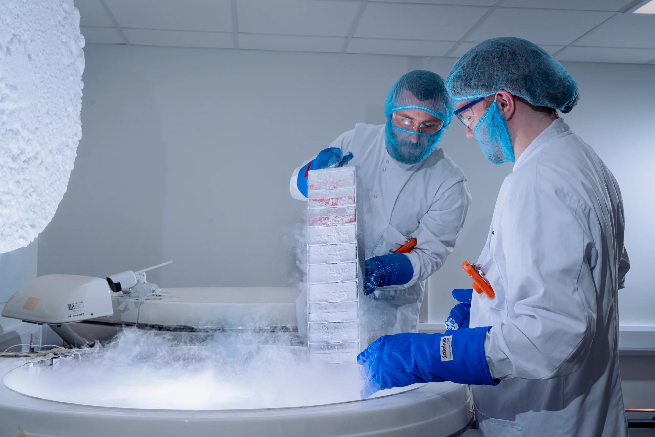 Two Biofortuna colleagues wearing PPE, retrieving samples from -196C controlled storage