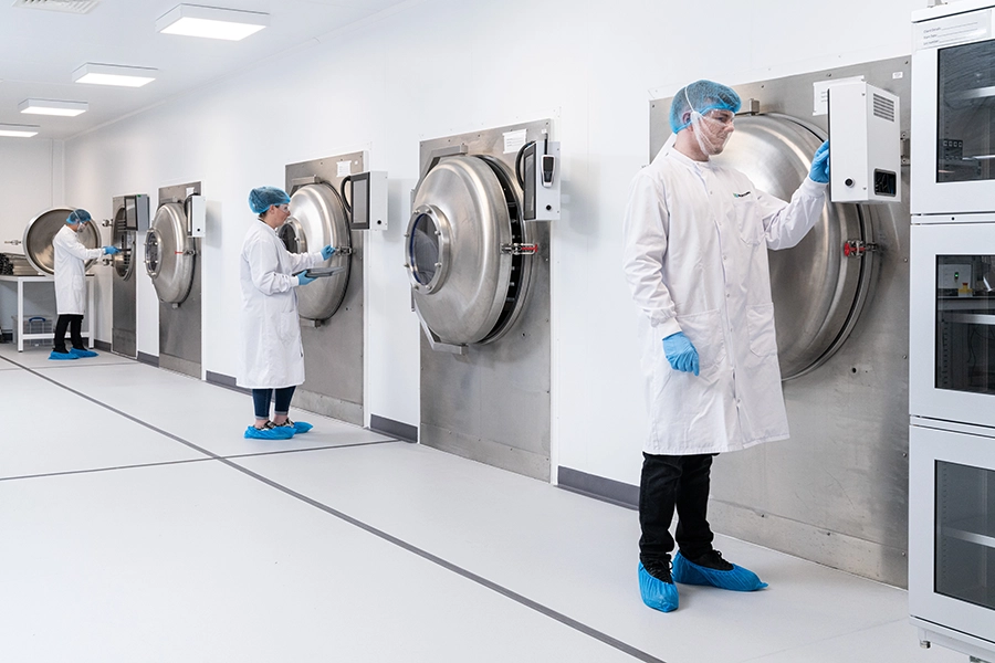 Biofortuna colleagues in PPE, operating their freeze dryers in ISO 7 cleanroom